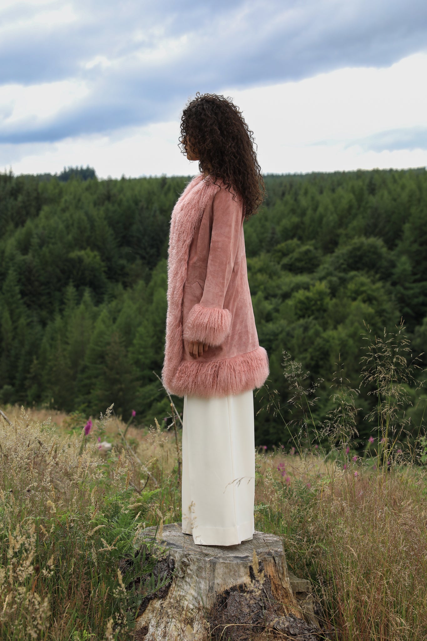 Blush genuine suede Afghan Penny Lane coat with mid-length design and crew neck, crafted by Josephine Jones.' This alt text provides a concise description of the coat, including its color, material, style, and designer, ensuring accessibility for visually impaired users.