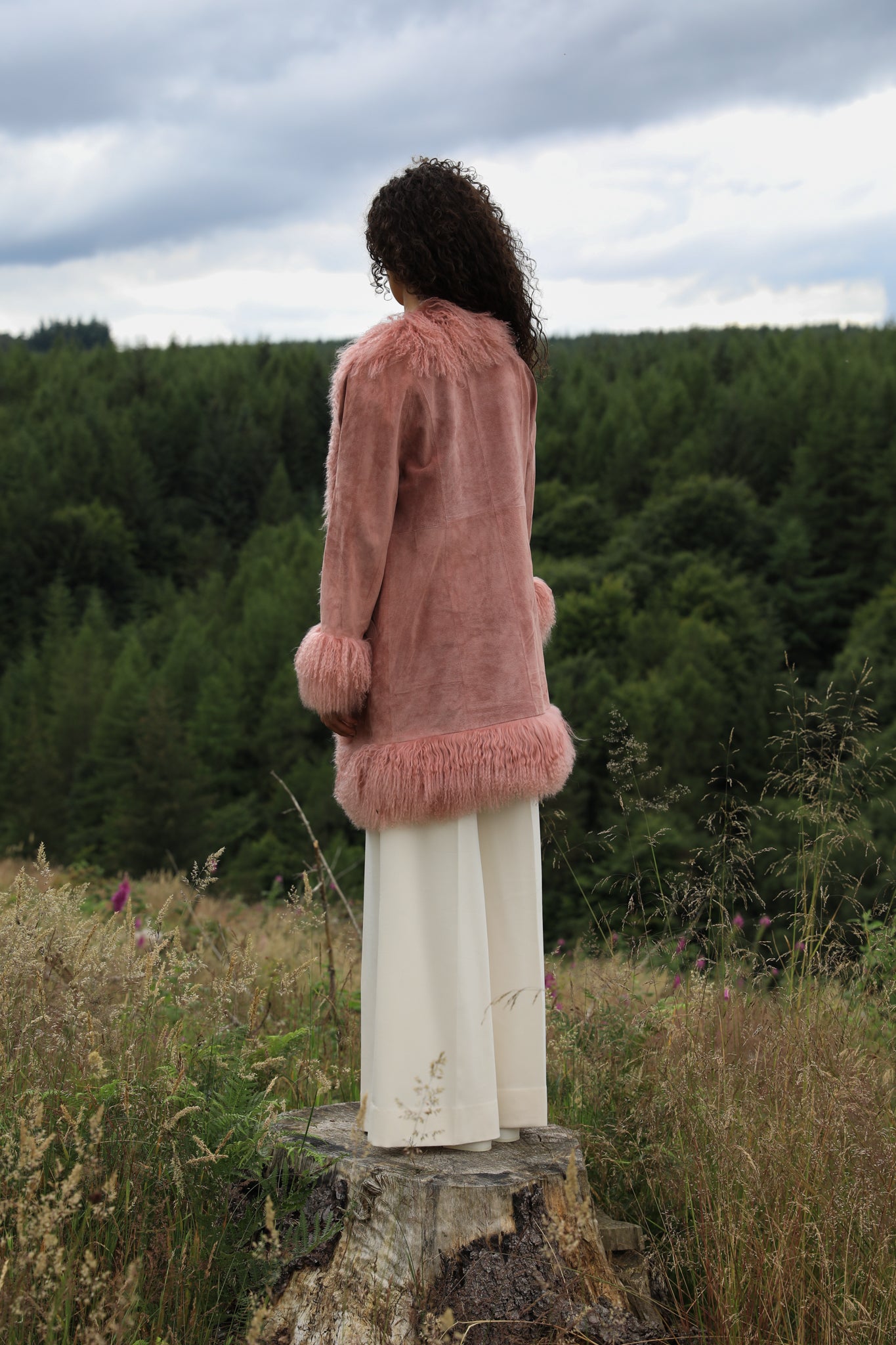 Blush genuine suede Afghan Penny Lane coat with mid-length design and crew neck, crafted by Josephine Jones.' This alt text provides a concise description of the coat, including its color, material, style, and designer, ensuring accessibility for visually impaired users.