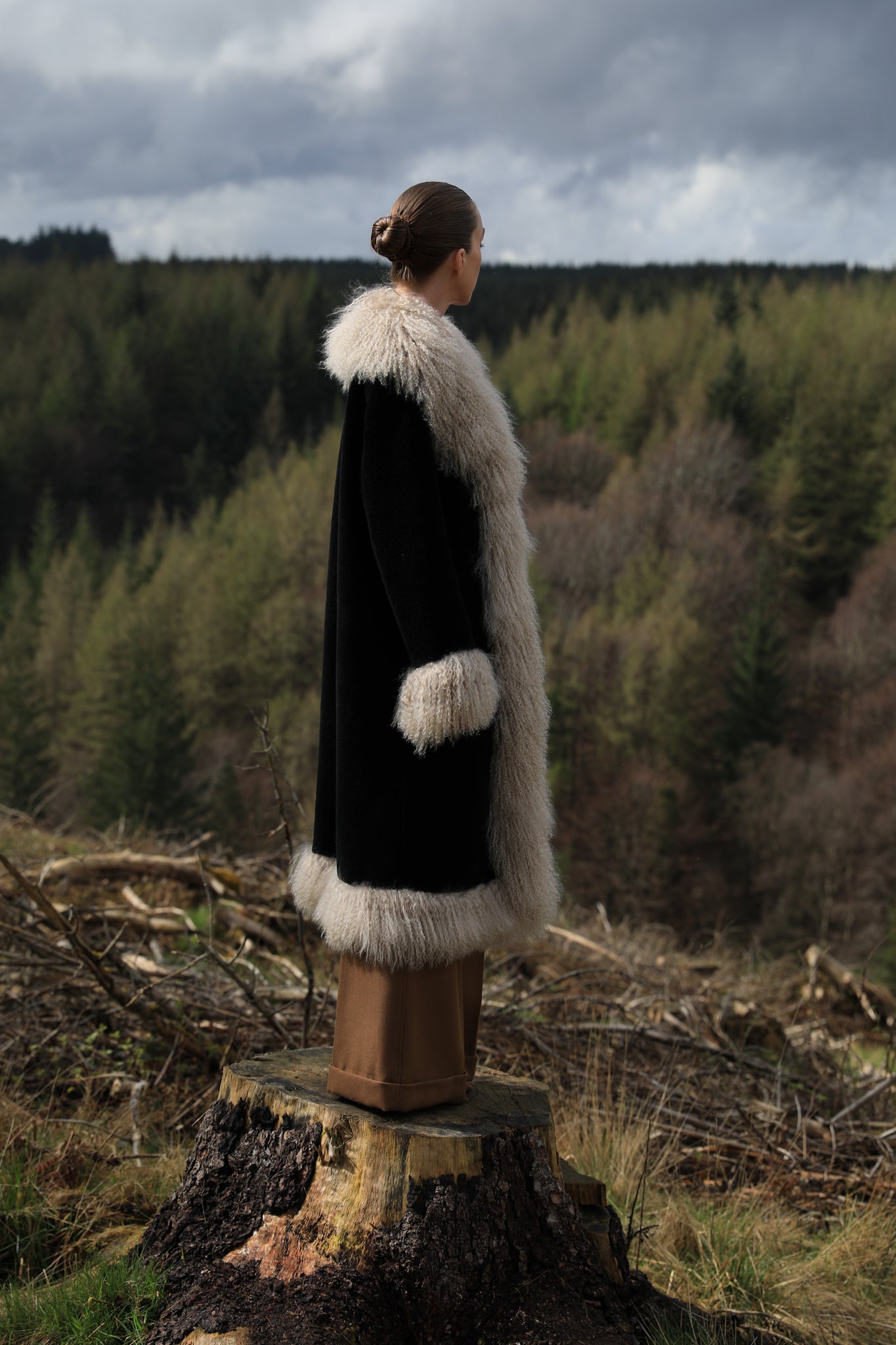 Josephine Jones bestselling long genuine shearling coat in beige and black, adorned with luxurious Mongolian fur trims. Stay chic and cozy in this elegant outerwear essential.