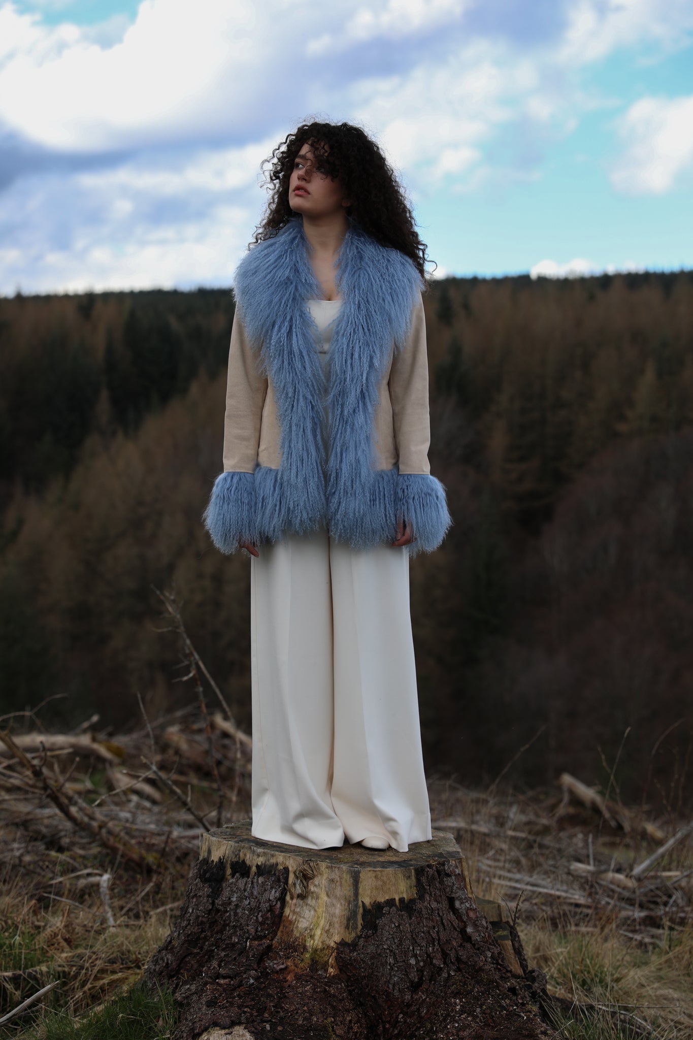 Josephine Jones' ivory suede Afghan penny lane style jacket adorned with cornflower blue Mongolian fur trims, offering a timeless and luxurious addition to any wardrobe.