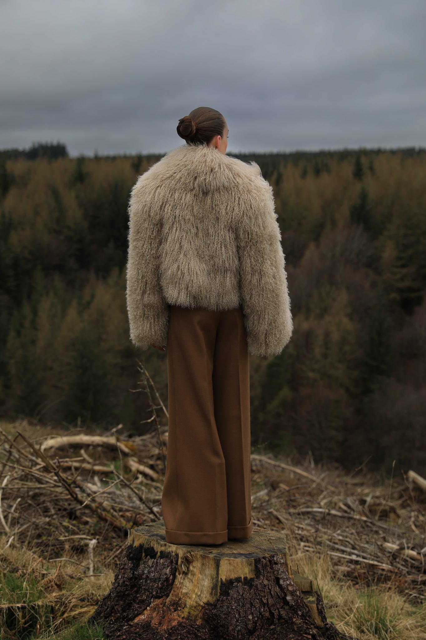 A  timeless beige Mongolian fur coat with a voluminous collar, a classic staple piece from Josephine Jones, exuding elegance and sophistication.