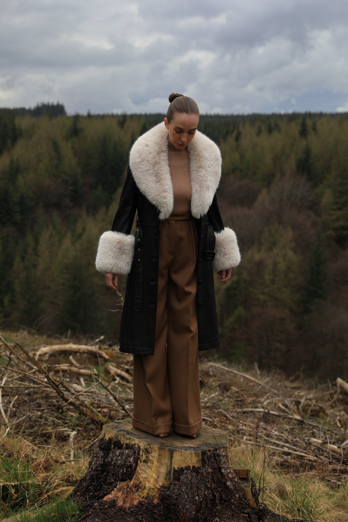 Josephine Jones' iconic black trench coat with oat faux fur collar and cuffs, crafted from genuine leather. A timeless blend of sophistication and warmth, perfect for elevating your winter style.