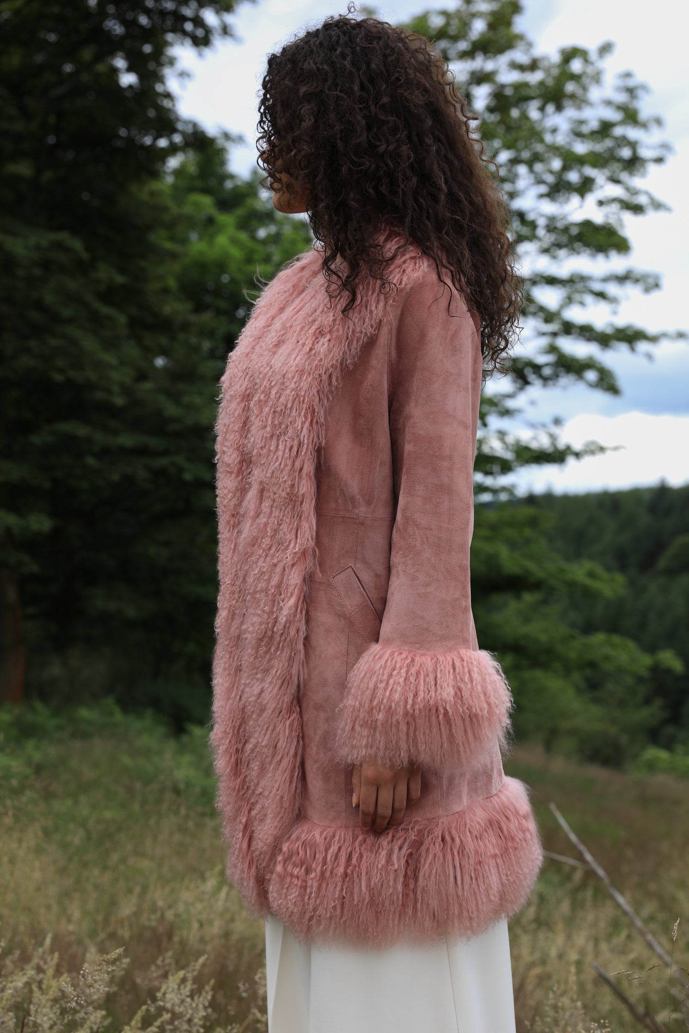 Blush genuine suede Afghan Penny Lane coat with mid-length design and crew neck, crafted by Josephine Jones.' This alt text provides a concise description of the coat, including its color, material, style, and designer, ensuring accessibility for visually impaired users.