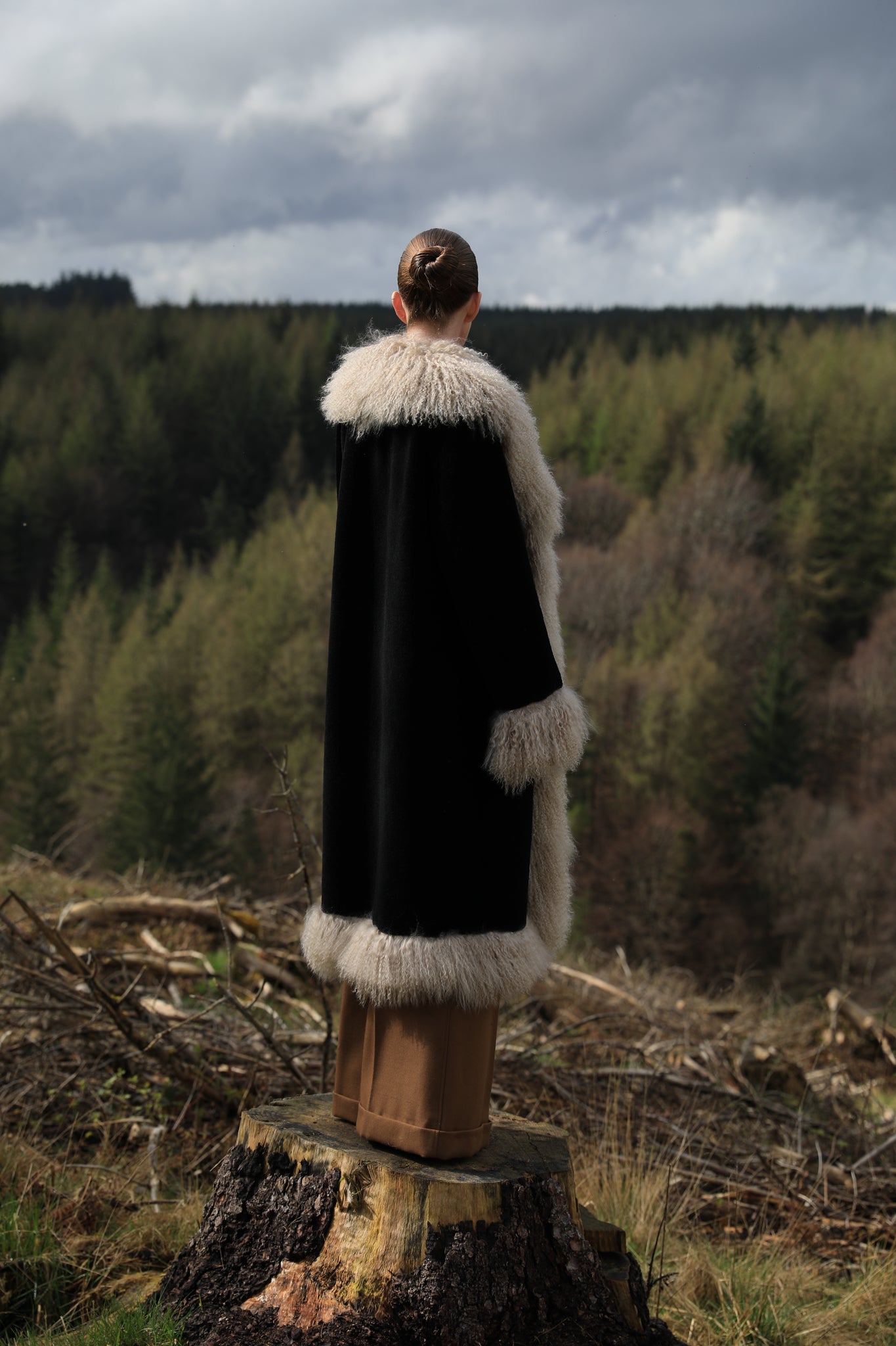 Josephine Jones bestselling long genuine shearling coat in beige and black, adorned with luxurious Mongolian fur trims. Stay chic and cozy in this elegant outerwear essential.