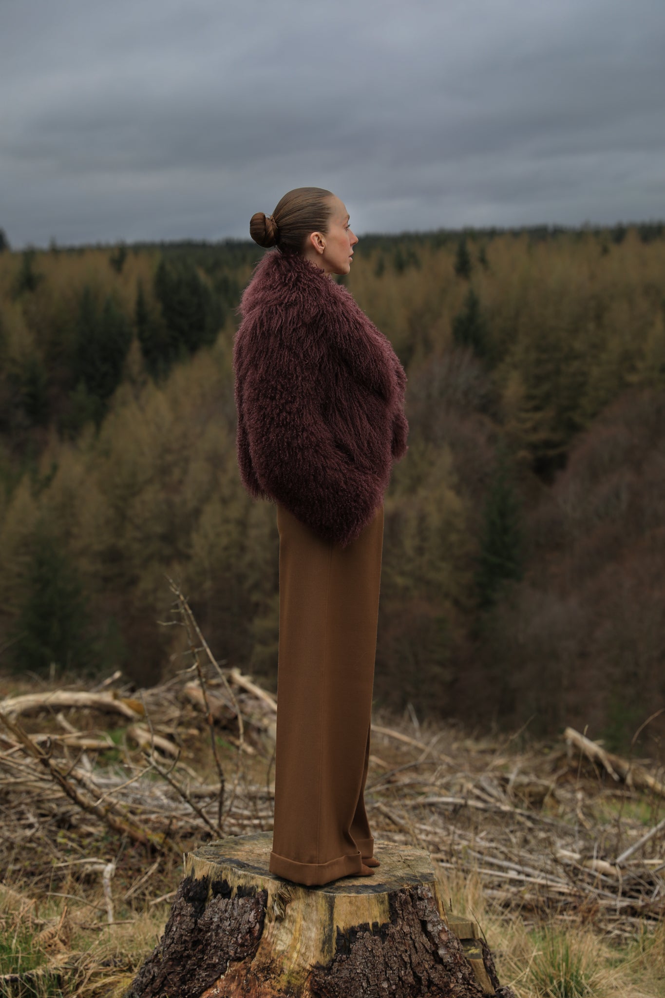  A burgundy voluminous collar Mongolian fur coat from Josephine Jones, a classic staple piece exuding elegance and luxury.