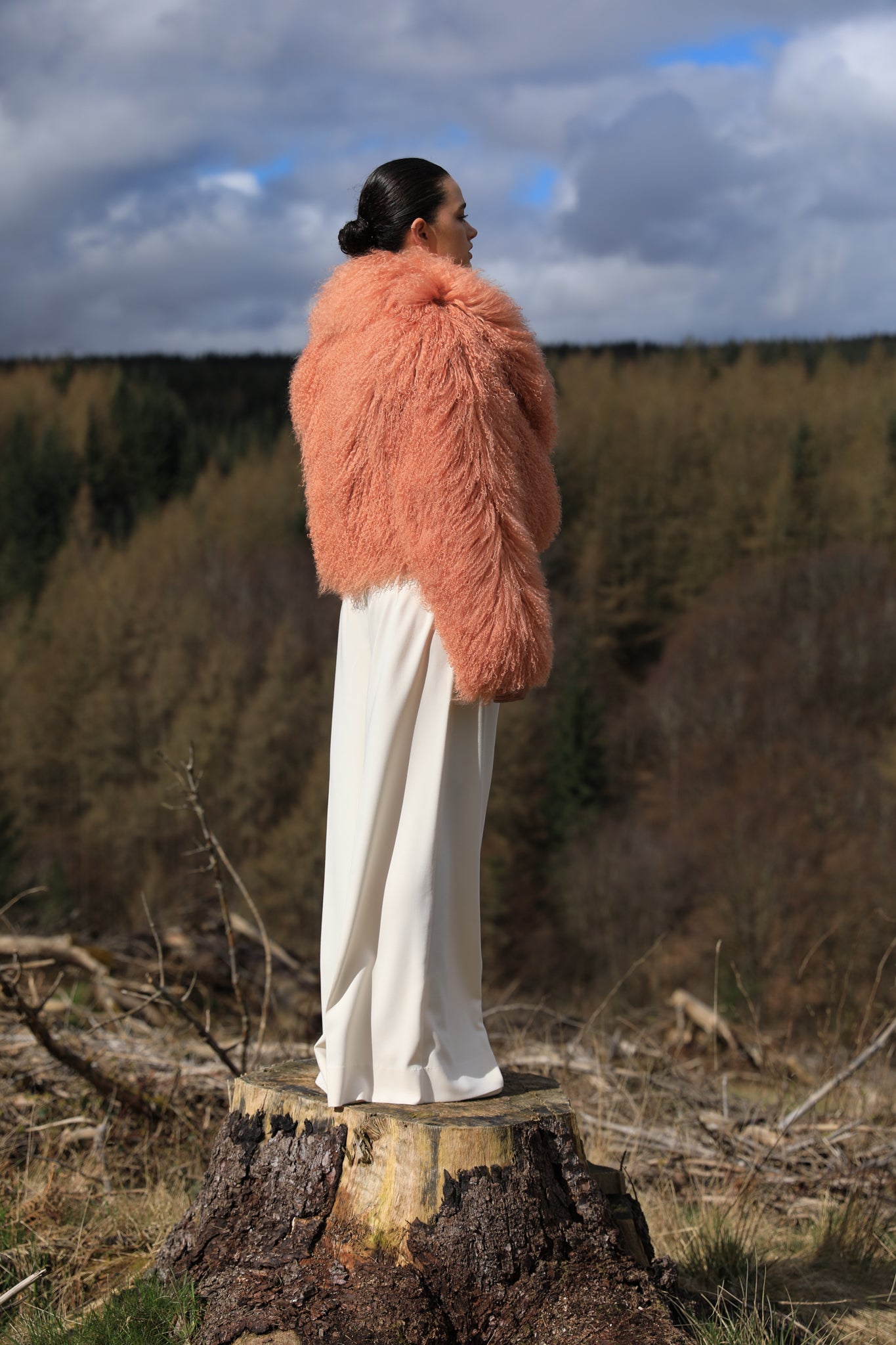 A timeless statement piece - Josephine Jones' voluminous collar Mongolian fur coat in peach hue, exuding elegance and luxury.