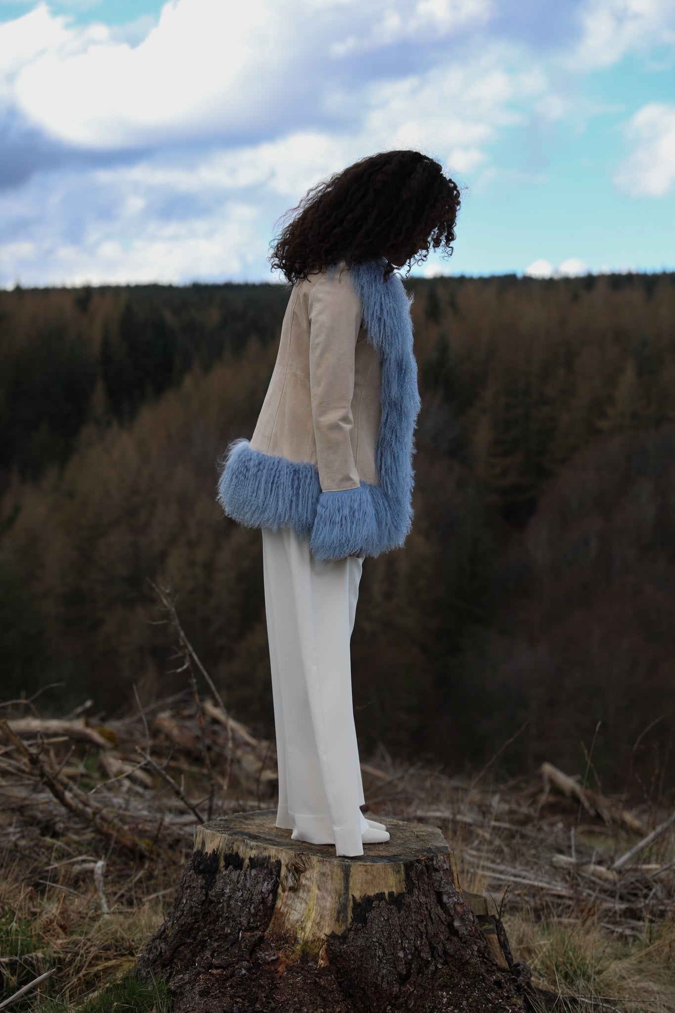 Josephine Jones' ivory suede Afghan penny lane style jacket adorned with cornflower blue Mongolian fur trims, offering a timeless and luxurious addition to any wardrobe.