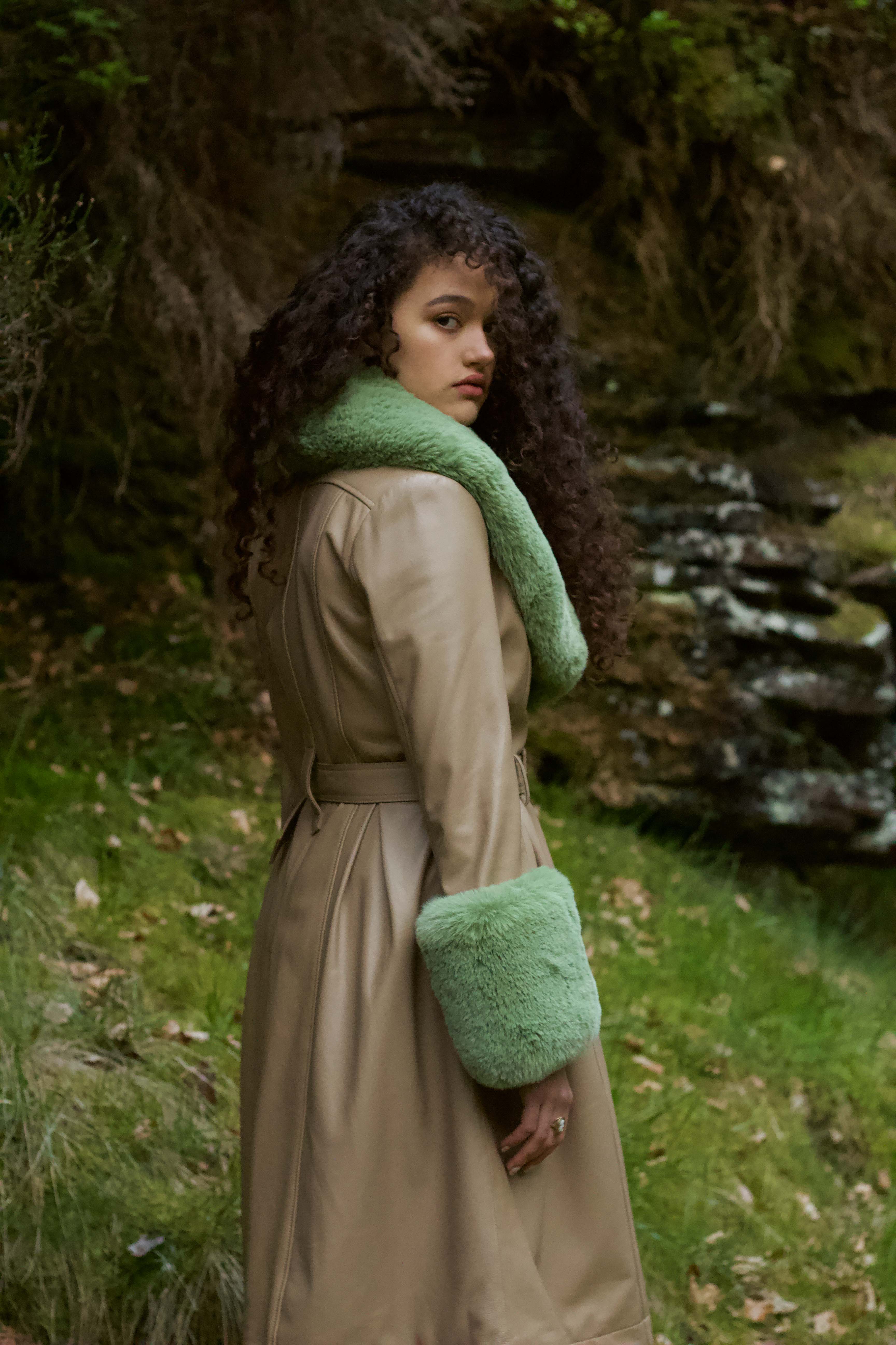 Beige trench coat with pistachio green faux fur collar and cuffs, crafted from genuine leather by Josephine Jones, offering timeless elegance and luxurious warmth for any occasion.