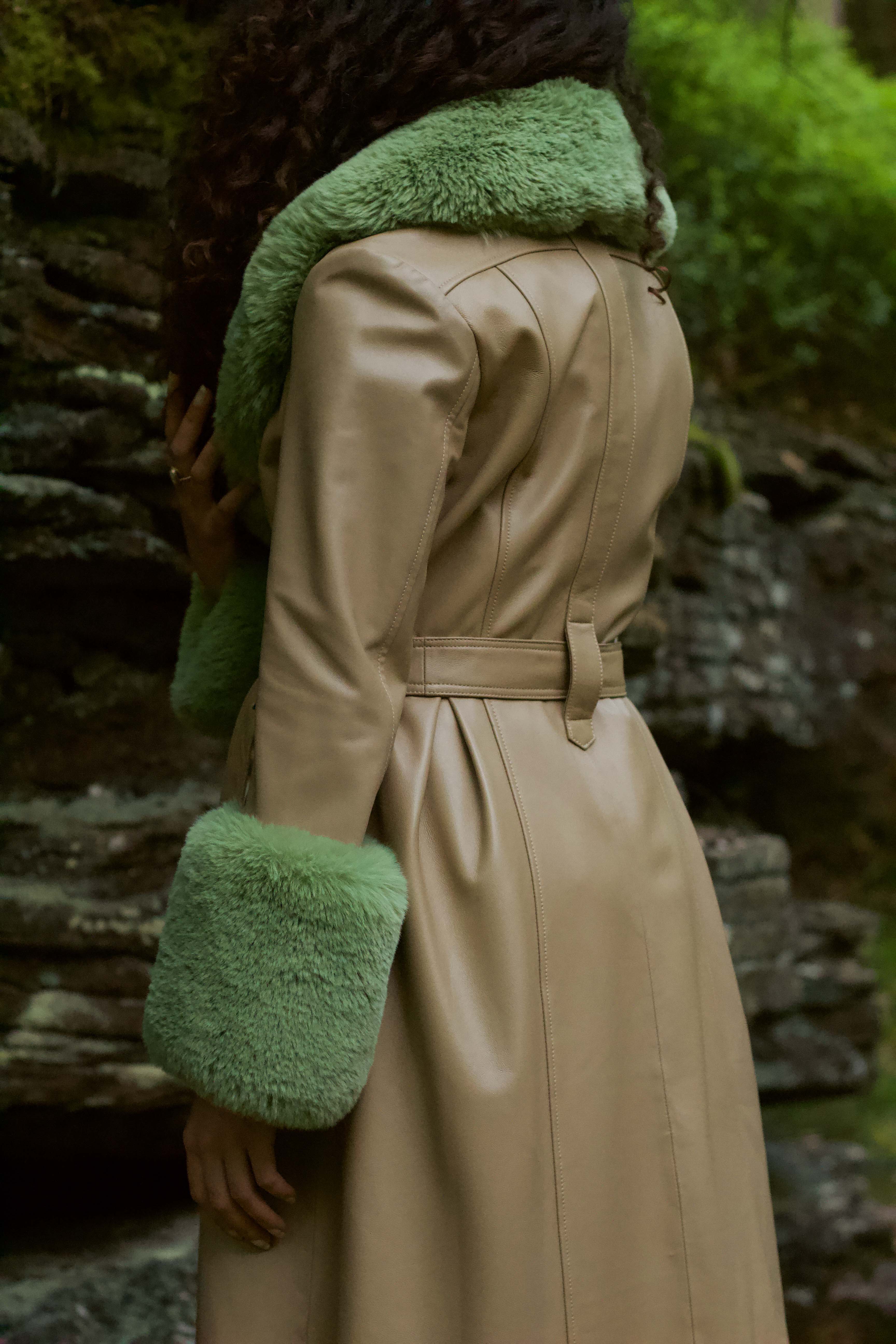 Beige trench coat with pistachio green faux fur collar and cuffs, crafted from genuine leather by Josephine Jones, offering timeless elegance and luxurious warmth for any occasion.