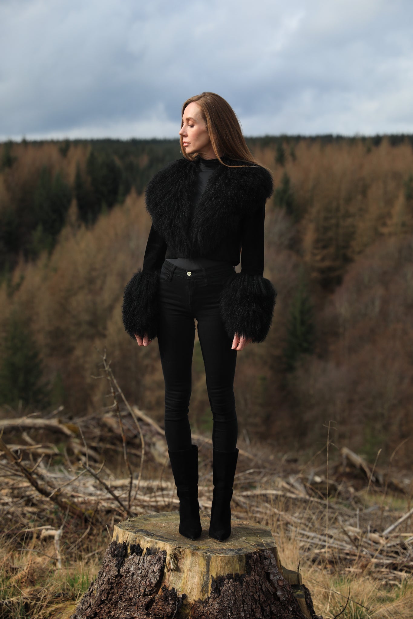  A sophisticated black genuine suede cropped jacket coat from Josephine Jones, featuring a luxurious Mongolian collar and cuffs. Perfect for adding a touch of elegance to any outfit.