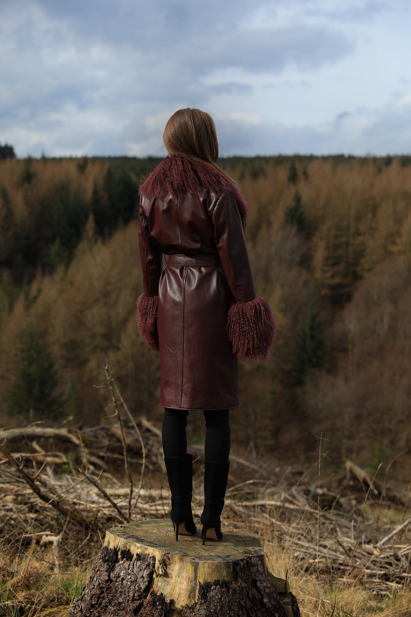 Burgundy genuine leather trench wrap coat with Mongolian collar and cuffs, designed by Josephine Jones. Luxurious outerwear exuding elegance and style