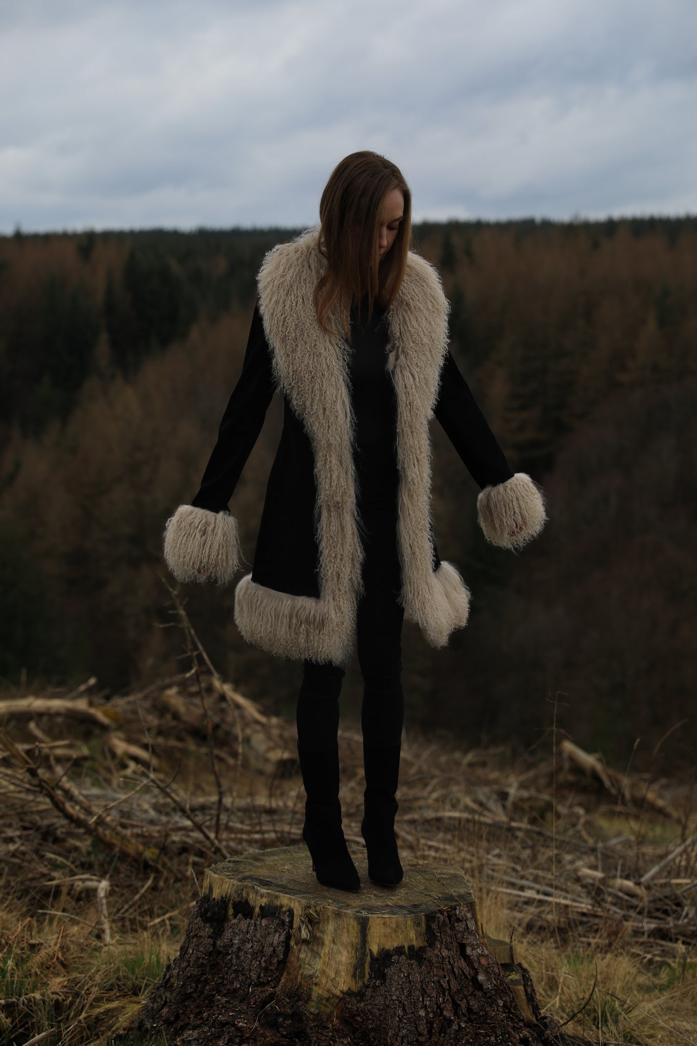 Josephine Jones' timeless black suede midi jacket with beige Mongolian fur trims, exuding classic Afghan Penny Lane style.