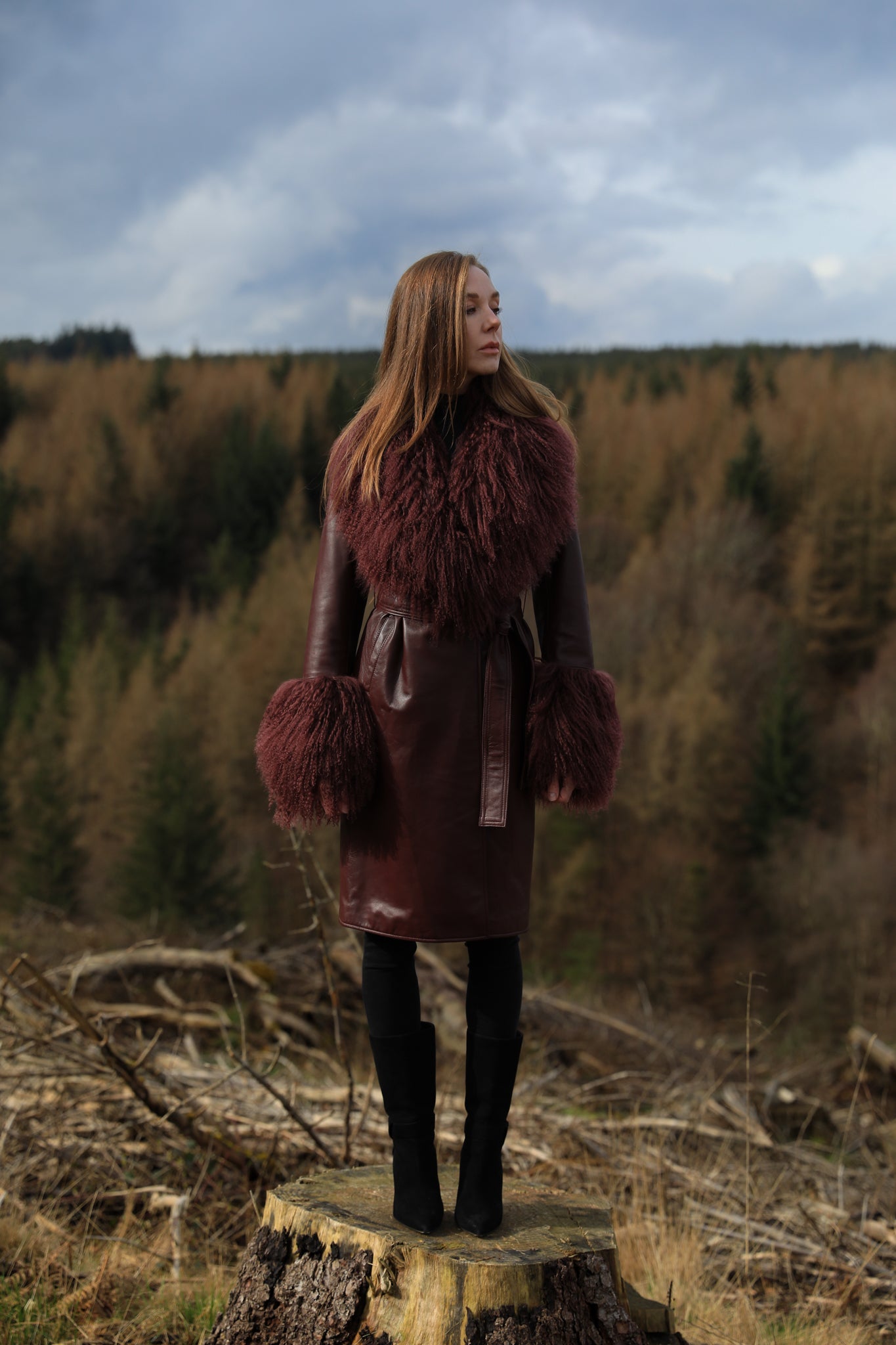 Burgundy genuine leather trench wrap coat with Mongolian collar and cuffs, designed by Josephine Jones. Luxurious outerwear exuding elegance and style