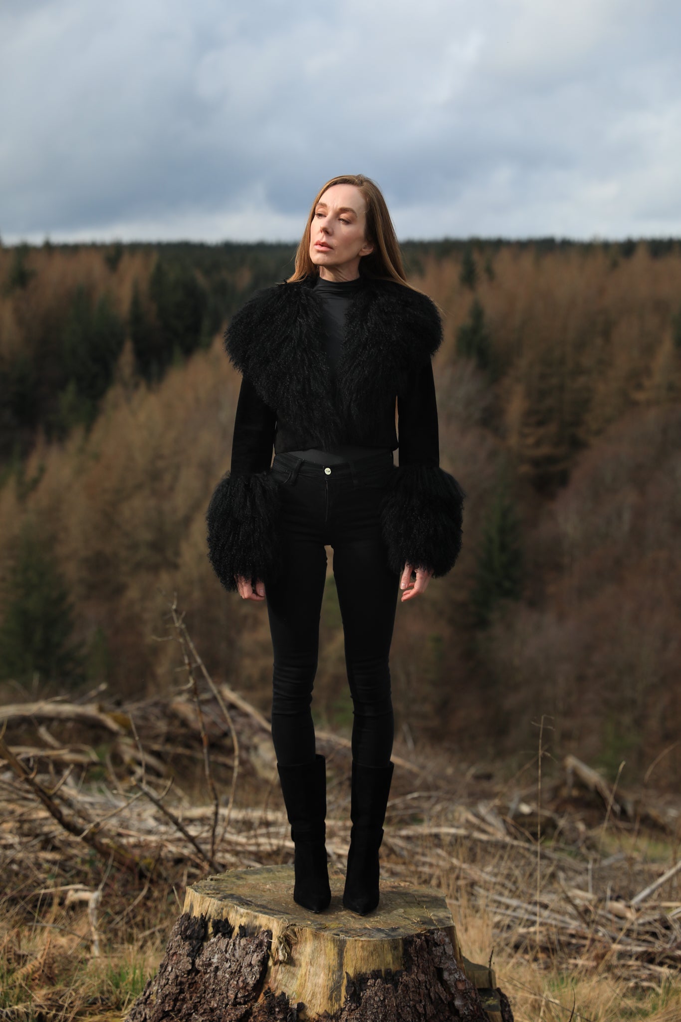  A sophisticated black genuine suede cropped jacket coat from Josephine Jones, featuring a luxurious Mongolian collar and cuffs. Perfect for adding a touch of elegance to any outfit.