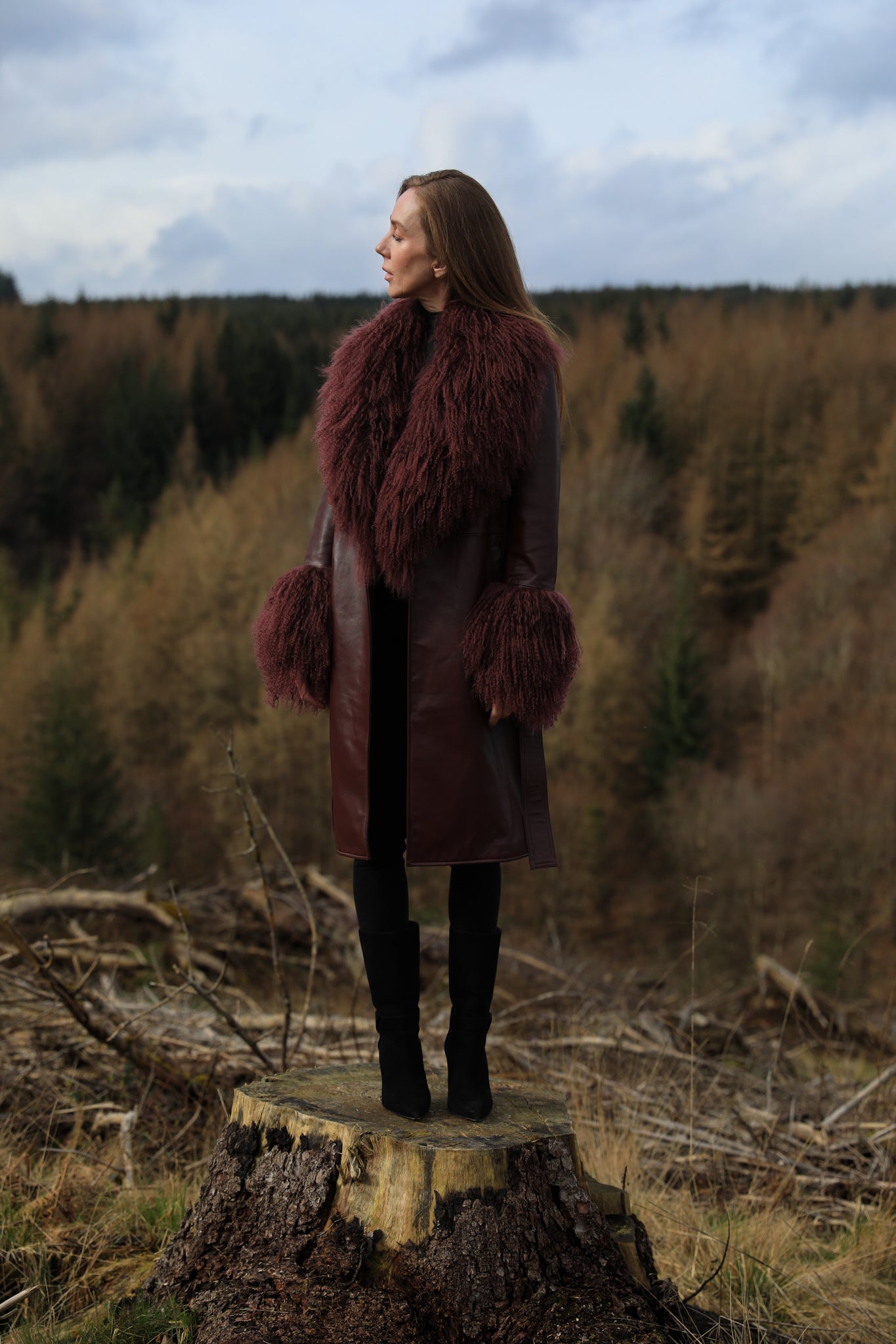 Burgundy genuine leather trench wrap coat with Mongolian collar and cuffs, designed by Josephine Jones. Luxurious outerwear exuding elegance and style