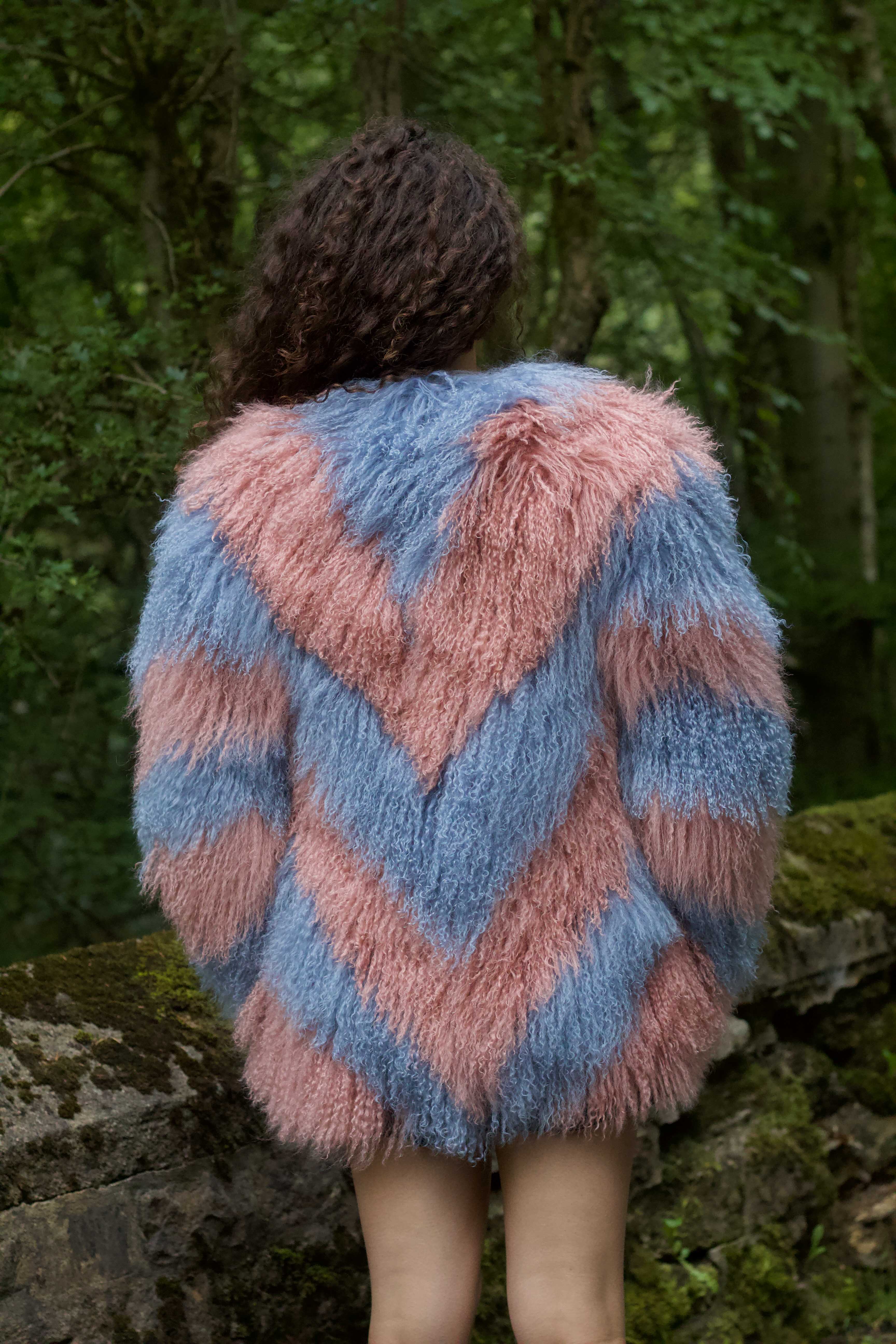 Elevate your style with Olivia in Blush, a full mid-length fur coat featuring elegant blush and cornflower blue zigzags.