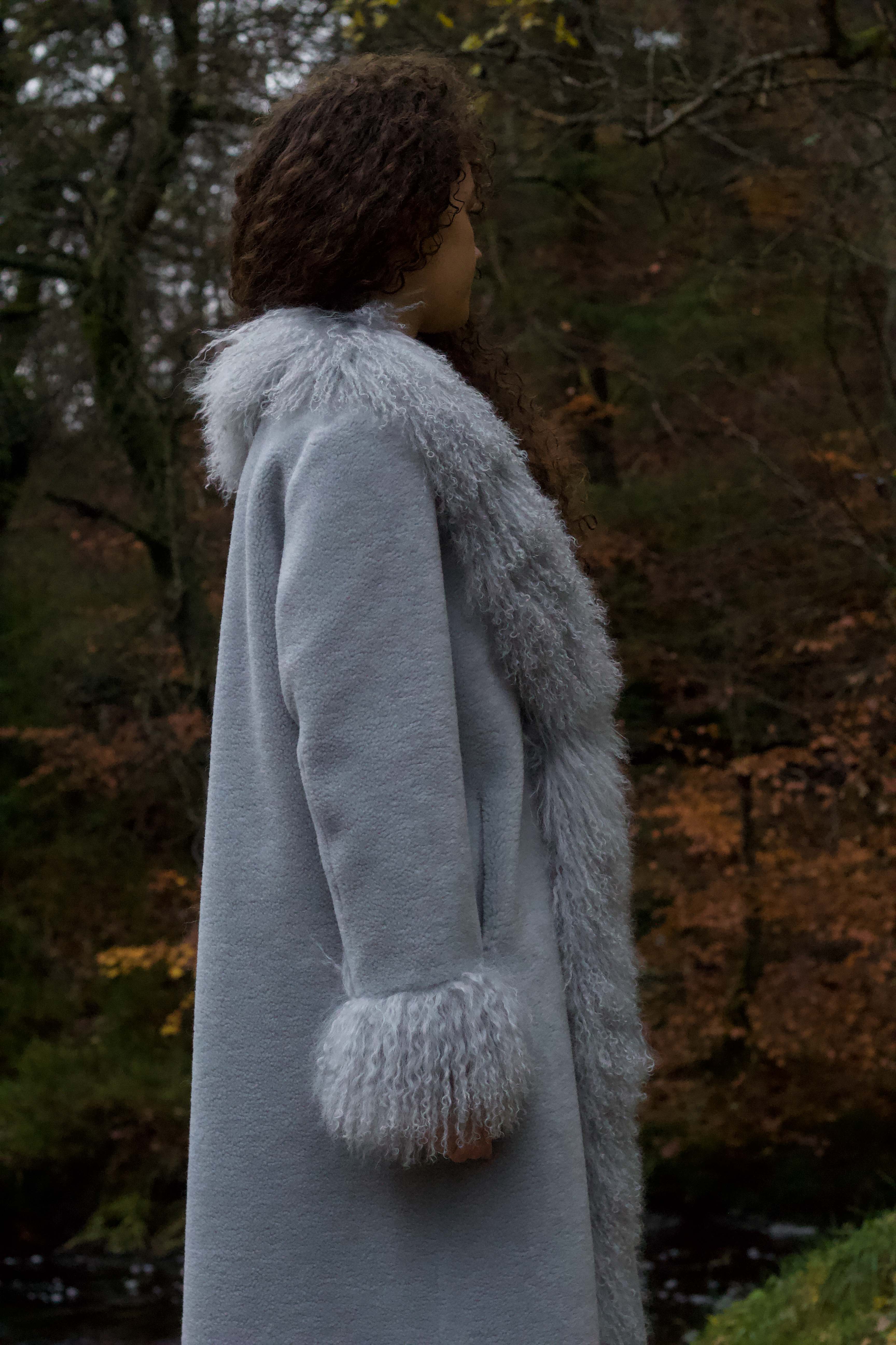 Josephine Jones bestselling long genuine shearling coat in grey, featuring exquisite Mongolian fur trims. Elevate your winter style with this luxurious outerwear essential.