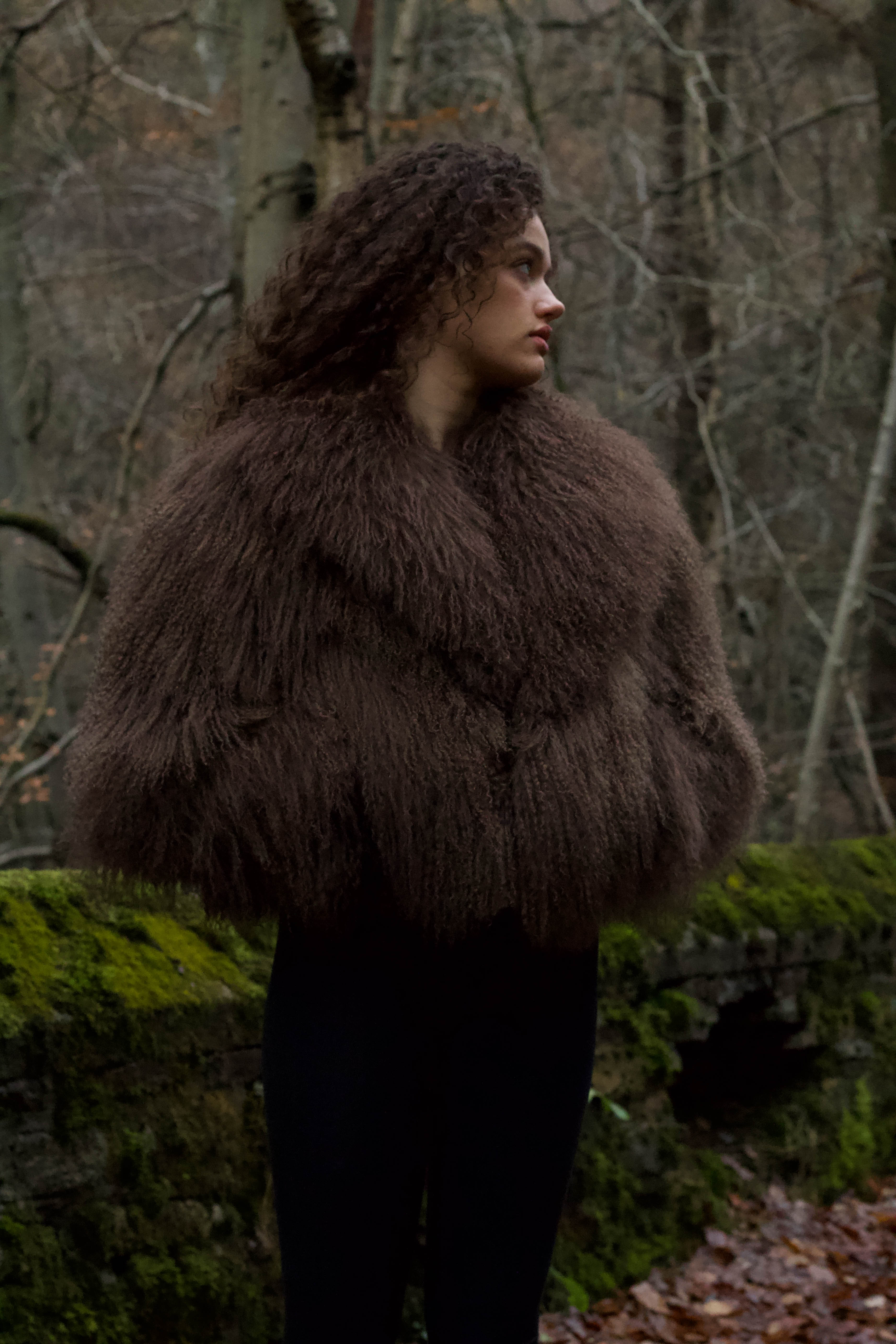 Josephine Jones' signature chocolate-colored Mongolian fur coat, featuring a voluminous collar. A luxurious staple piece perfect for adding warmth and elegance to any ensemble.