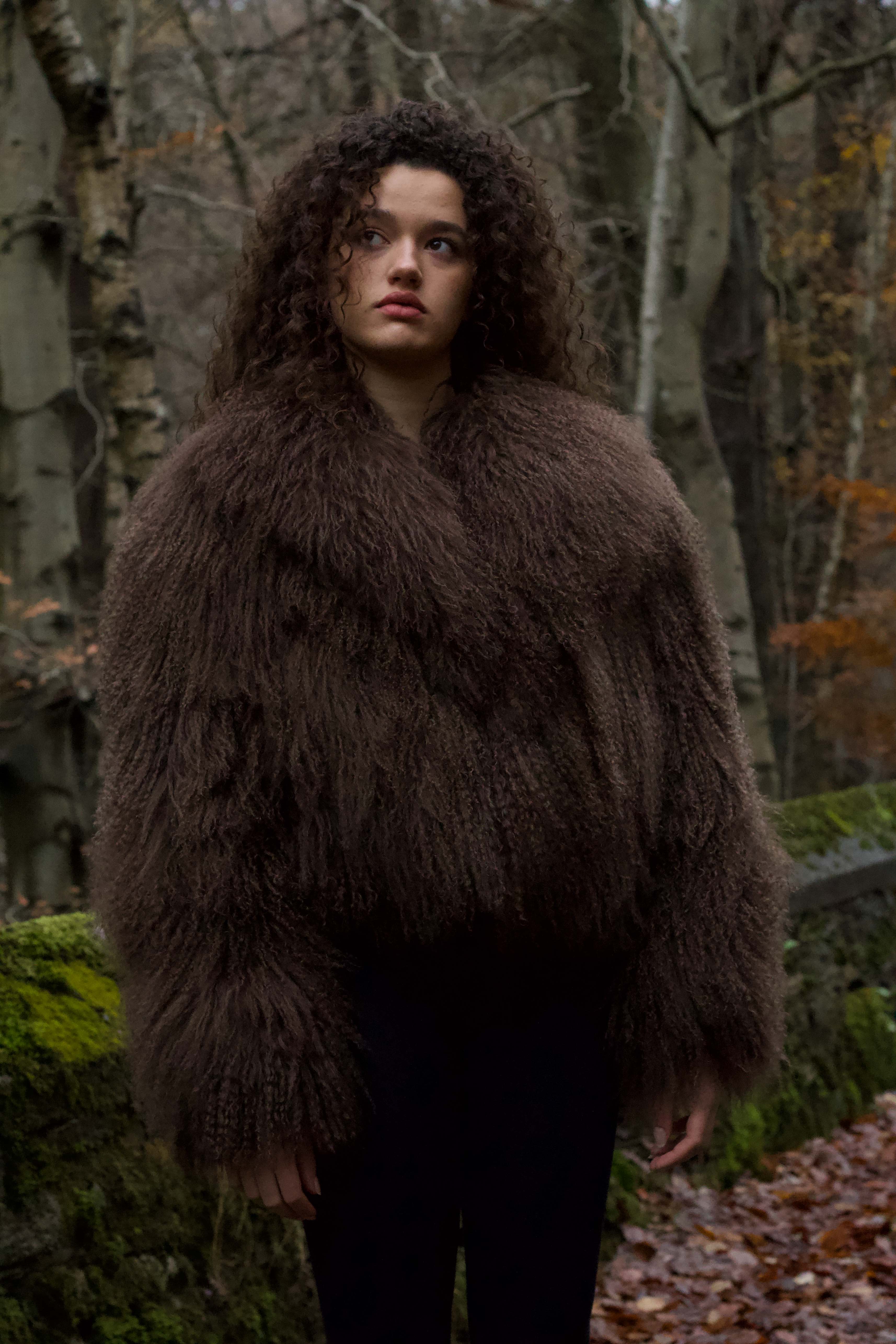 Josephine Jones' signature chocolate-colored Mongolian fur coat, featuring a voluminous collar. A luxurious staple piece perfect for adding warmth and elegance to any ensemble.